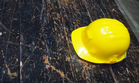 yellow hard hat on wooden floor